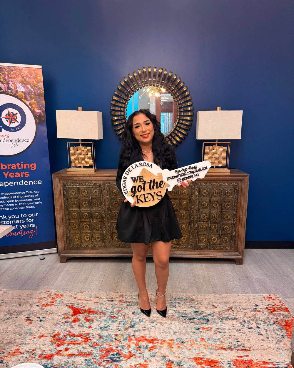 A buyer holding a We Got the Keys sign on closing day