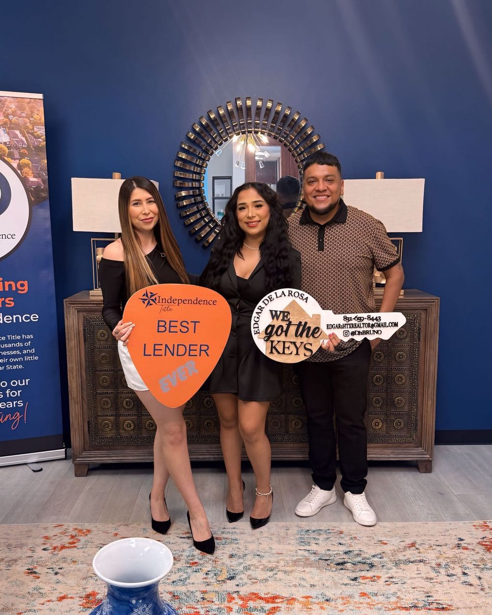 Buyers holding Best Lender Ever and We Got the Keys signs with Ana