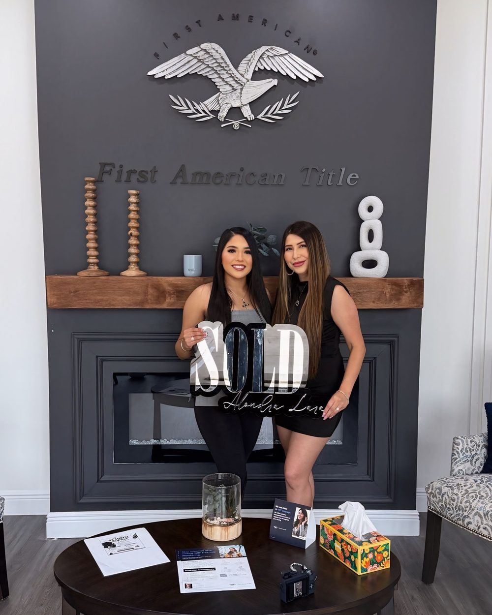A buyer holding a Sold sign with Ana on closing day