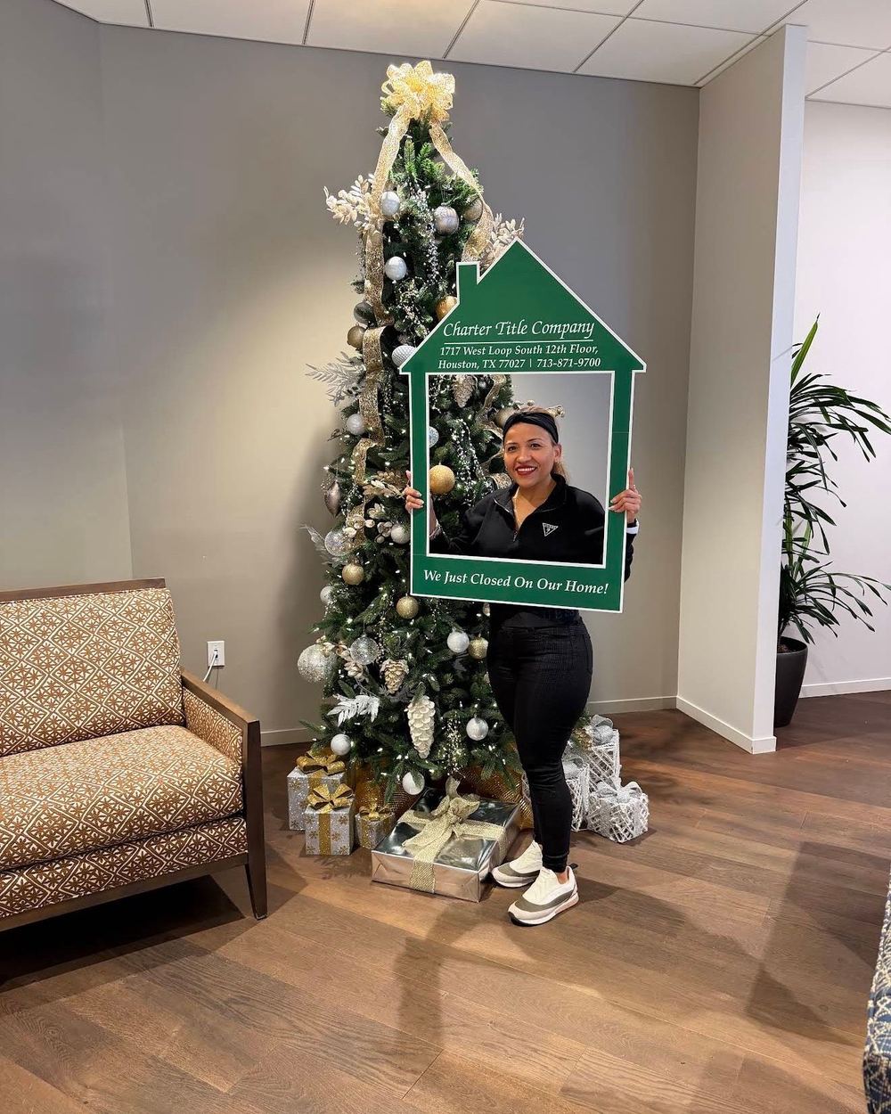 A buyer holding a Charter Title We Just Closed On Our Home frame