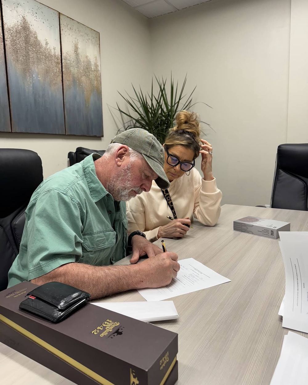 Buyers signing their closing documents at the title company