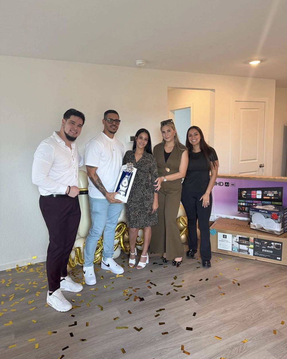 Buyers celebrating with gold confetti in their empty living room
