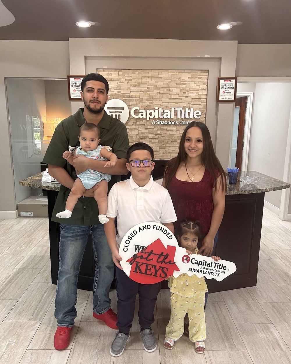 A young family with their children at the Capital Title closing table