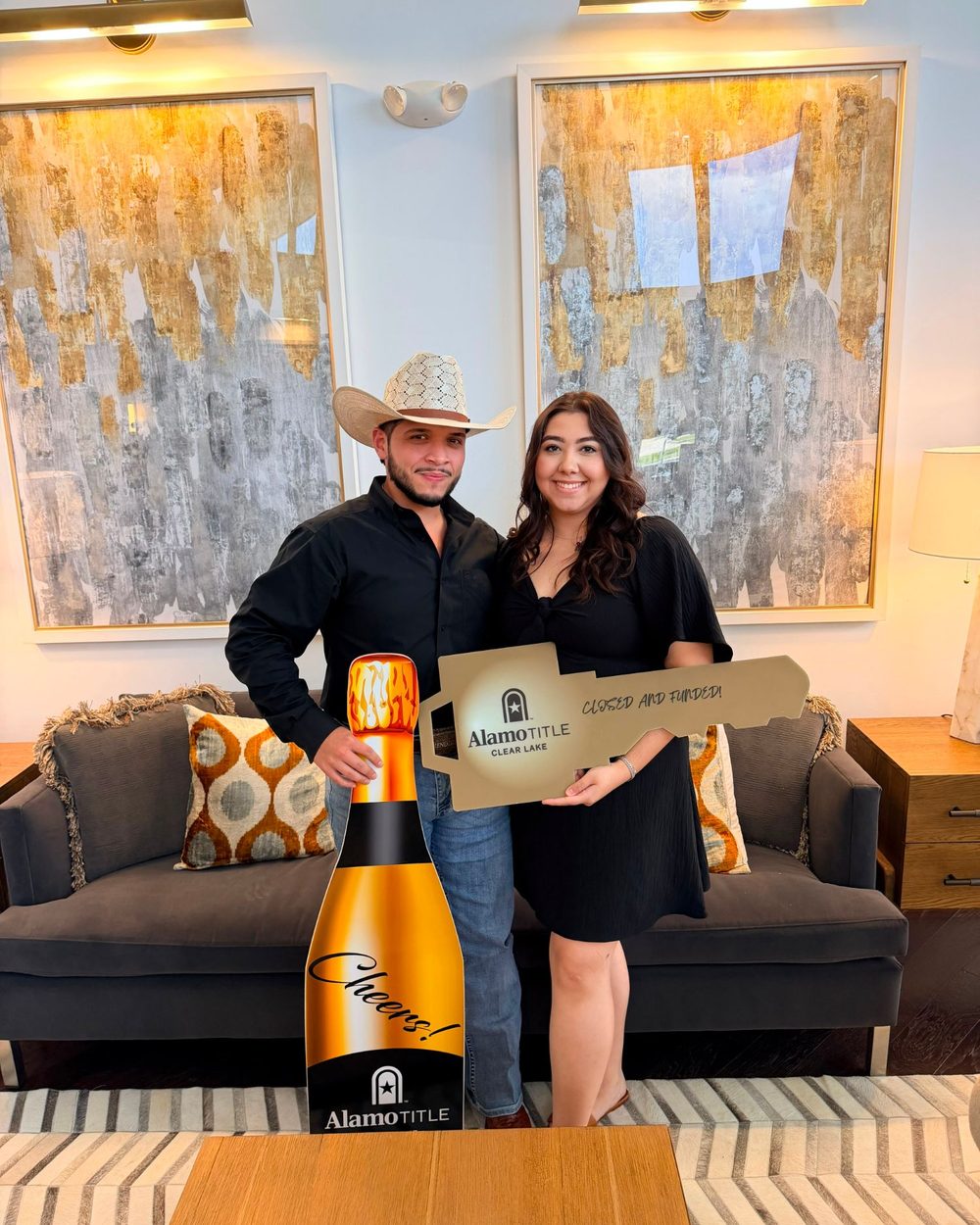 A couple holding a Closed and Funded key on closing day