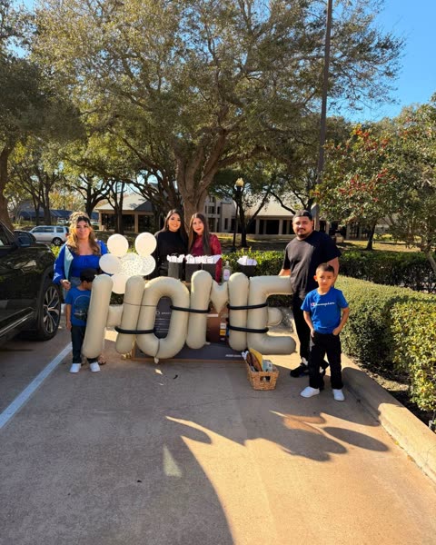 A Houston family on closing day with HOME balloon letters