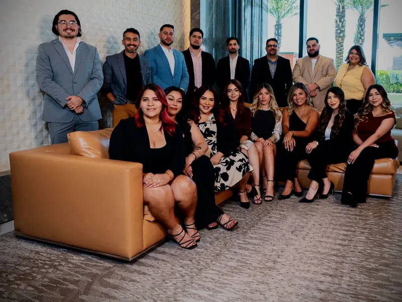 The Warens Financial Group team seated and standing together in an office lobby